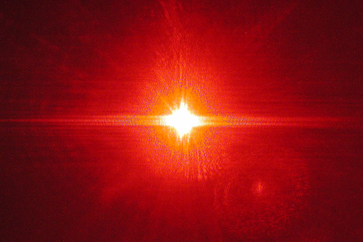 Single slit interference of a red laser through a small opening