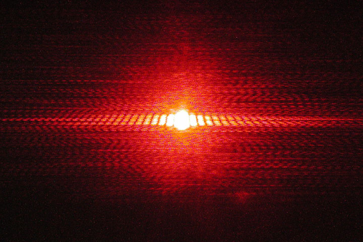 Single slit interference of a red laser through a small opening