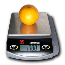 Valencia orange on an electronic balance reading 178.0 grams